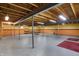 Unfinished basement with exposed ceiling, support beams, cement floor, and half painted walls at 12404 Rose Haven Dr, Indianapolis, IN 46235
