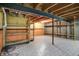 Unfinished basement with exposed ceiling, support beams, tiled floor, half painted walls, and wooden shelves at 12404 Rose Haven Dr, Indianapolis, IN 46235