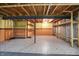 Unfinished basement with exposed ceiling, support beams, tiled floor, half painted walls, and wooden shelves at 12404 Rose Haven Dr, Indianapolis, IN 46235