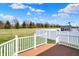 The outdoor deck creates a cozy retreat with a white fence and a tranquil view of the manicured backyard at 12404 Rose Haven Dr, Indianapolis, IN 46235