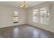 Open dining area with hardwood floors and natural light from the large windows at 12404 Rose Haven Dr, Indianapolis, IN 46235