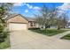 Inviting brick home with a two-car garage and a spacious driveway, great curb appeal at 12404 Rose Haven Dr, Indianapolis, IN 46235