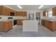 Well-lit kitchen with stainless steel appliances, a center island, and wood cabinets at 12404 Rose Haven Dr, Indianapolis, IN 46235