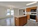Kitchen with island, wooden cabinets, stainless steel appliances and view to dining area at 12404 Rose Haven Dr, Indianapolis, IN 46235