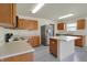 Well-lit kitchen with stainless steel refrigerator and island, providing extra counter space at 12404 Rose Haven Dr, Indianapolis, IN 46235