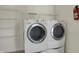 Laundry room featuring a side-by-side washer and dryer with metal shelving at 12404 Rose Haven Dr, Indianapolis, IN 46235