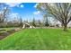 Community playground with slides, swings, and mature trees, ideal for outdoor fun and relaxation at 12404 Rose Haven Dr, Indianapolis, IN 46235
