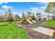 Community playground with slides, swings, and mature trees, ideal for outdoor fun and relaxation at 12404 Rose Haven Dr, Indianapolis, IN 46235