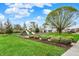Community playground with slides, swings, and mature trees, ideal for outdoor fun and relaxation at 12404 Rose Haven Dr, Indianapolis, IN 46235