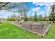 Community playground with slides, swings, and mature trees, ideal for outdoor fun and relaxation at 12404 Rose Haven Dr, Indianapolis, IN 46235