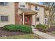 Townhouse exterior with red front door, brick accents, and manicured landscaping at 12570 Timber Creek Dr # 7, Carmel, IN 46032