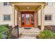 Inviting covered entrance featuring a bright red door and brick accents at 12570 Timber Creek Dr # 7, Carmel, IN 46032
