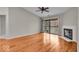 Open living space with wood floors, fireplace, and sliding door to outdoor deck at 12570 Timber Creek Dr # 7, Carmel, IN 46032