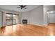 Spacious living room with wood floors, fireplace, and sliding glass door to balcony at 12570 Timber Creek Dr # 7, Carmel, IN 46032