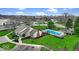 Aerial view of community pool and lounge area with manicured lawns and trees at 12570 Timber Creek Dr # 7, Carmel, IN 46032