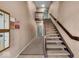 Carpeted stairway to the upper level features wood railings and painted walls at 12570 Timber Creek Dr # 7, Carmel, IN 46032