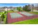 Two fenced tennis courts, perfect for recreational activities, set in a green space at 12570 Timber Creek Dr # 7, Carmel, IN 46032
