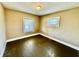 Bright bedroom with hardwood floors, neutral walls, and two large windows at 1302 Lindley Ave, Indianapolis, IN 46241