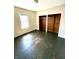 Bedroom with natural light and hardwood floors with an empty closet at 1302 Lindley Ave, Indianapolis, IN 46241