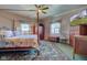 Cozy bedroom featuring a four-poster bed, ceiling fan, and bright windows at 1325 Fordice Rd, Lebanon, IN 46052