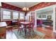 Cozy dining room with hardwood floors, floral wallpaper, and seamless access to living area at 1325 Fordice Rd, Lebanon, IN 46052