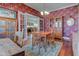 Charming dining room featuring wood table/chairs, floral wallpaper, and french doors to sunroom at 1325 Fordice Rd, Lebanon, IN 46052