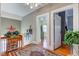 Hallway with hardwood floors, area rug, table with flowers, and open doorways to other rooms at 1325 Fordice Rd, Lebanon, IN 46052
