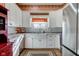 Bright kitchen featuring white cabinets, farmhouse sink, stainless appliances, and a charming window at 1325 Fordice Rd, Lebanon, IN 46052