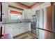 Bright kitchen with white cabinetry, farmhouse sink, stainless steel appliances, and granite countertops at 1325 Fordice Rd, Lebanon, IN 46052