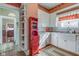 Charming kitchen with white cabinets, granite countertops, a farmhouse sink, and decorative red accents at 1325 Fordice Rd, Lebanon, IN 46052
