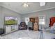 Living room with a TV, a ceiling fan, a leather chair, a sofa, and a gray rug at 1325 Fordice Rd, Lebanon, IN 46052