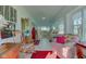 Spacious sunroom with white paneling, large windows, and comfortable seating arrangements at 1325 Fordice Rd, Lebanon, IN 46052