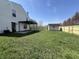 Expansive backyard showing a new fence, shed, patio, and pergola connected to the home at 1404 Alonzo Pl, Indianapolis, IN 46217
