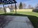 Spacious backyard featuring a wooden fence, shed, and patio area, perfect for outdoor activities at 1404 Alonzo Pl, Indianapolis, IN 46217