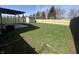 Large backyard with a well-maintained lawn, wooden fence, shed, and an installed air conditioning unit at 1404 Alonzo Pl, Indianapolis, IN 46217