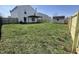 View of the spacious backyard featuring new wooden fence, shed, pergola, and healthy lawn at 1404 Alonzo Pl, Indianapolis, IN 46217
