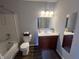 Bathroom featuring a tub, toilet, and vanity with a mirror, complete with a decorative touch at 1404 Alonzo Pl, Indianapolis, IN 46217