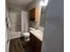 Bathroom features a shower-tub combo and wooden vanity at 1404 Alonzo Pl, Indianapolis, IN 46217
