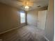 Comfortable bedroom with soft carpet, bright window, and door leading to other rooms at 1404 Alonzo Pl, Indianapolis, IN 46217