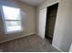 Cozy bedroom with a window view and bi-fold door closet storage space at 1404 Alonzo Pl, Indianapolis, IN 46217