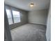 Bright bedroom with neutral walls, carpet, and natural light streaming through the windows at 1404 Alonzo Pl, Indianapolis, IN 46217