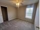 Bedroom featuring plush carpeting, a window, and a bi-fold closet door at 1404 Alonzo Pl, Indianapolis, IN 46217