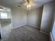 Bright bedroom with soft carpet features ceiling fan and view to the living space at 1404 Alonzo Pl, Indianapolis, IN 46217