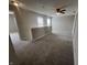 Upstairs bonus room featuring neutral paint, carpet, a ceiling fan, and natural light from several windows at 1404 Alonzo Pl, Indianapolis, IN 46217