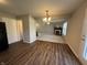 Dining room with wood floors and a view of living room with fireplace at 1404 Alonzo Pl, Indianapolis, IN 46217
