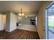 Open dining room with wood flooring, ceiling fan, and a view to the living room at 1404 Alonzo Pl, Indianapolis, IN 46217