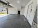 Bright garage showing a stained floor, water heater, overhead door, and access door at 1404 Alonzo Pl, Indianapolis, IN 46217