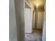 Hallway with neutral paint, plush carpet, closet, and doors leading to rooms at 1404 Alonzo Pl, Indianapolis, IN 46217