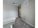 Upstairs hallway features neutral paint, carpet, white baseboards and door with a partial view of a doorway at 1404 Alonzo Pl, Indianapolis, IN 46217