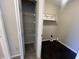 Convenient laundry area includes shelving for storage solutions at 1404 Alonzo Pl, Indianapolis, IN 46217